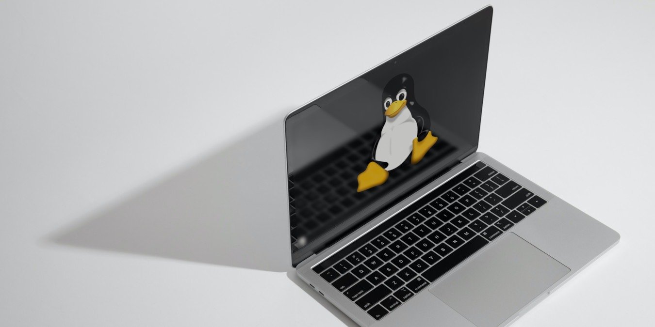 A photograph of a laptop on a white table.