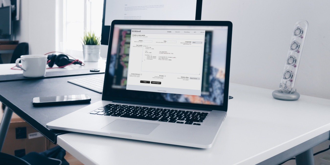 A photograph of a laptop on top of a white table.