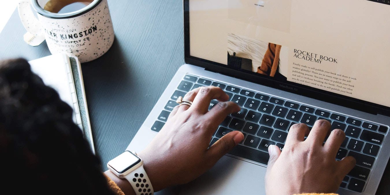 Person Editing Microsoft Word Document on Laptop