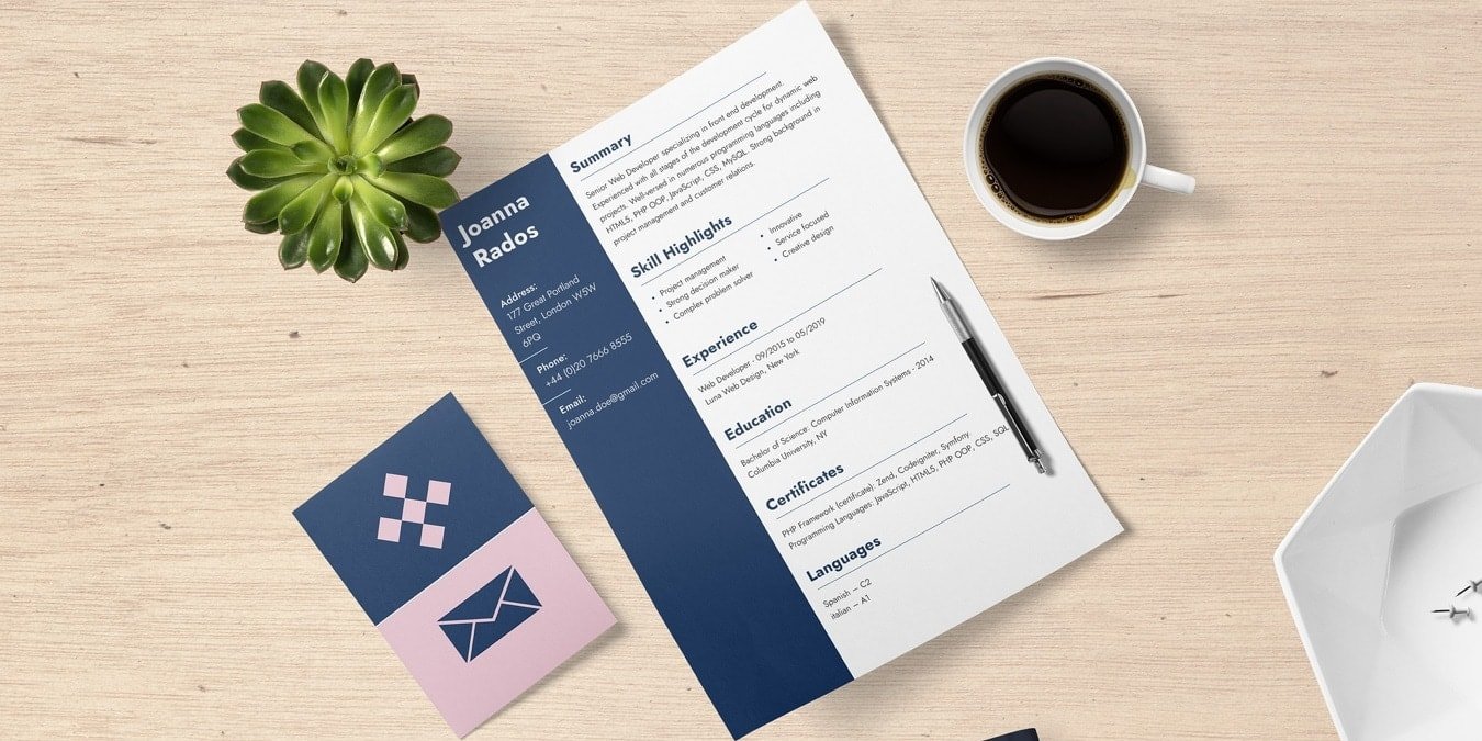Resume on a desk with coffee and a plant