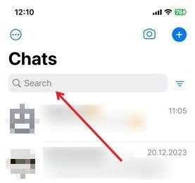 Using the search bar at the top of WhatsApp for iOS to search all chats.