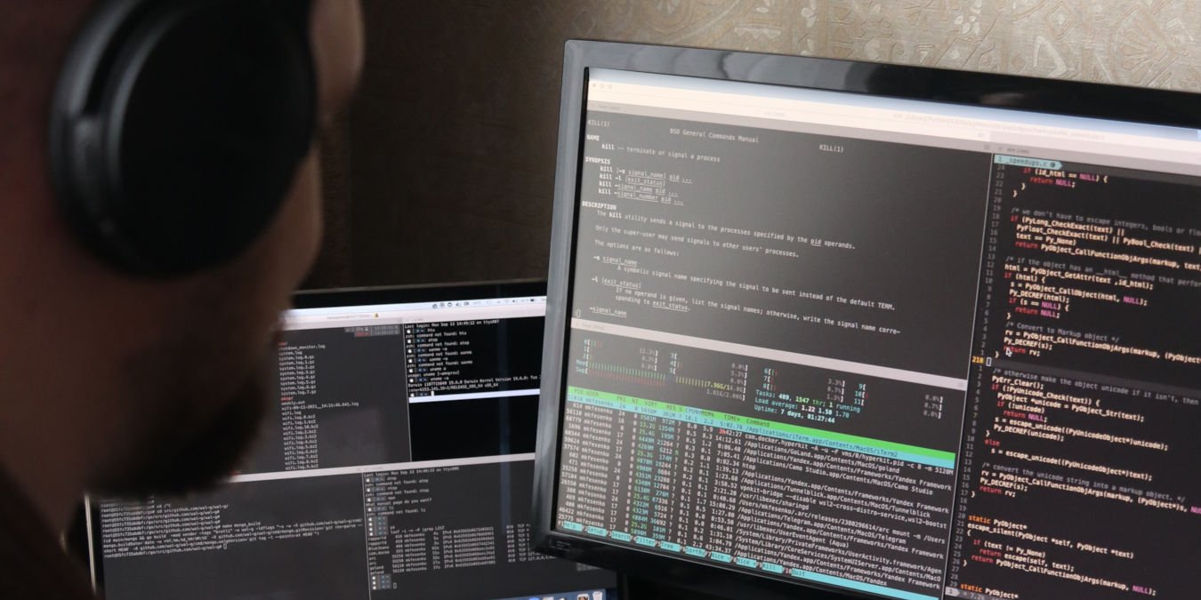 A photograph of a man working in front of his computer.
