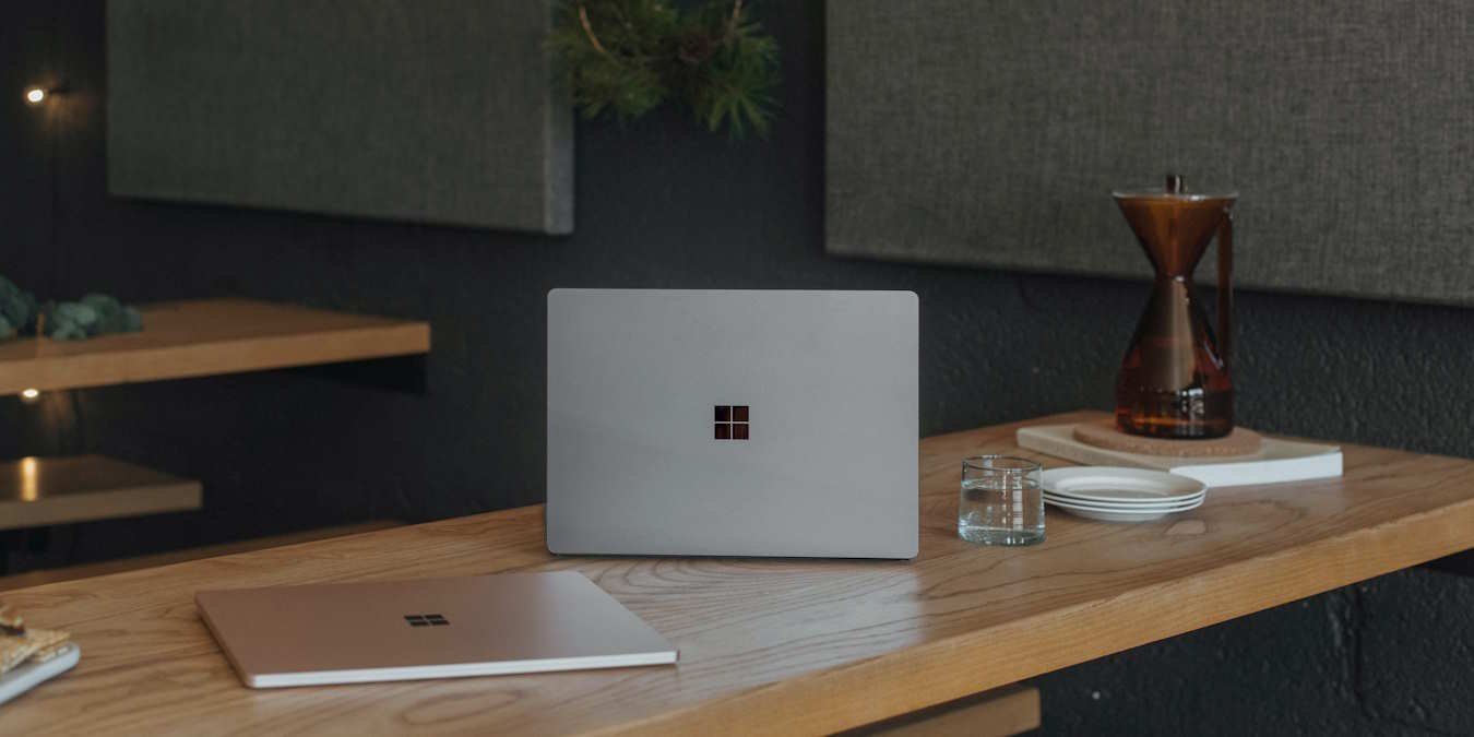 Windows Suface Laptops On A Wooden Table